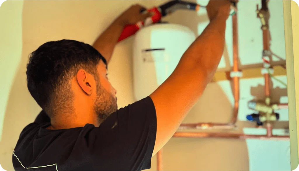 Professional boiler repair technician fixing a boiler in a home.